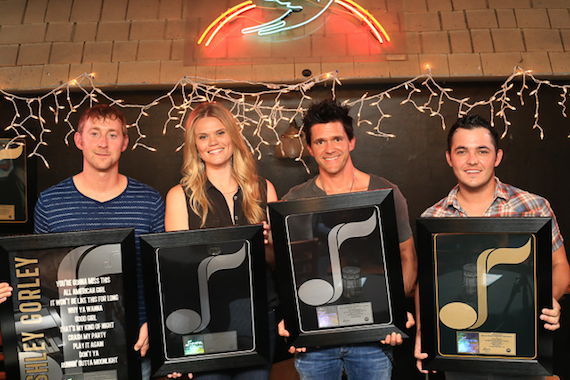 Pictured (L-R): Ashley Gorley, Nicolle Galyon, Michael Carter, Cole Taylor with their NMPA Songwriting Gold & Platinum Awards at the Bluebird Cafe. 